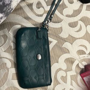 Light worn BIG wristlet. Coach